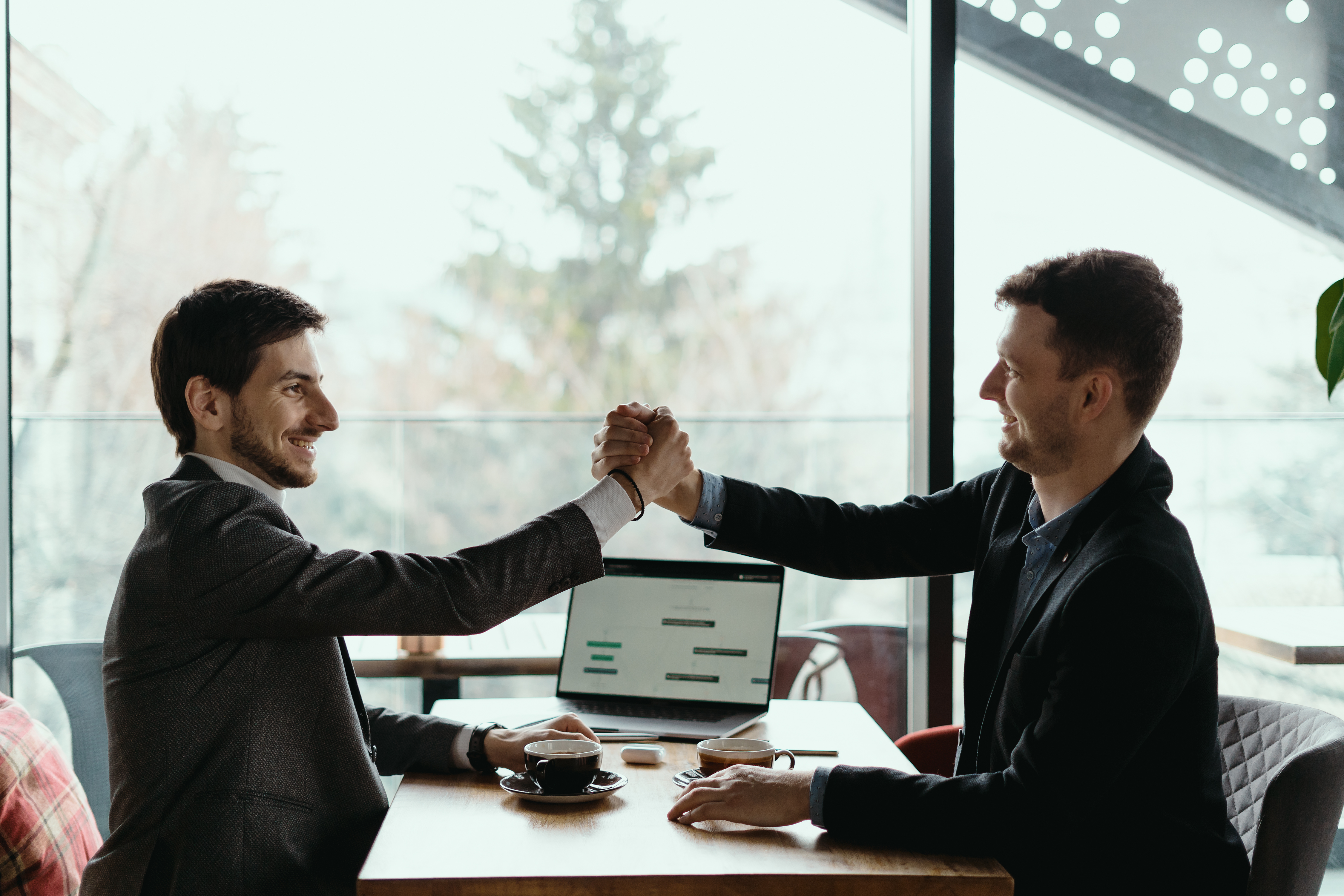 Businessman shaking hand to his partner on meeting, positive management team celebrating victory, successful stock deal, sales growth, won good contract, business achievement and teamwork concept